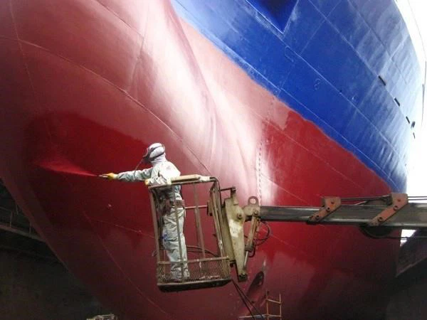 Person coating the vessel with anti-corrosive paint